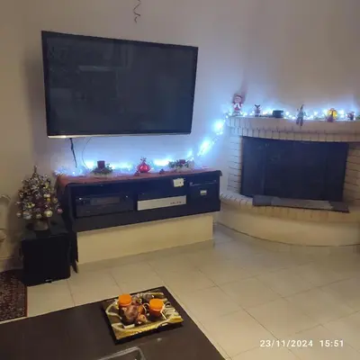 a living room with a television and a fireplace at Skyline Serenity in Lagonissi