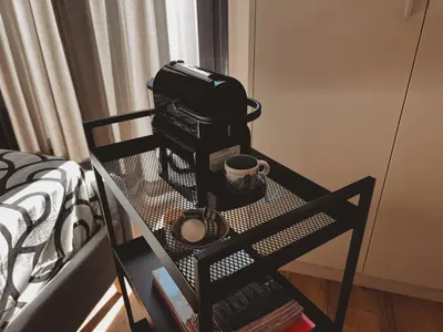 a coffee maker sitting on a table next to a bed at Cozy Studio in Zografou, close to hospitals in Athens