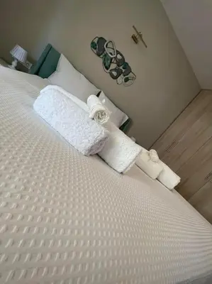 a bedroom with a bed with two towels on it at Urban Utopia in Athens