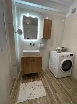 a bathroom with a washing machine and a sink at Urban Utopia in Athens