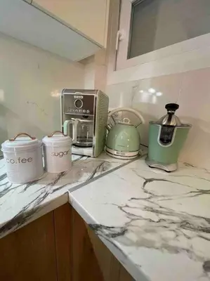 a kitchen counter with appliances on a marble counter top at Urban Utopia in Athens