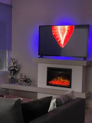 a living room with a fireplace with a heart on the tv at Urban Utopia in Athens