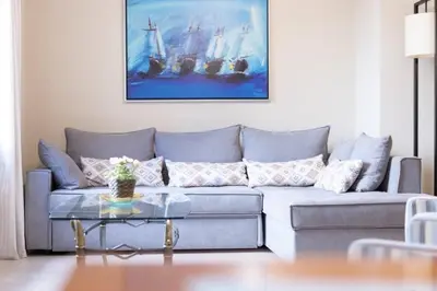a living room with a couch and a table at Renovated fully equipped 2 Bedroom cozy Apartment near the sea in Athens