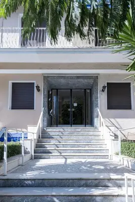 a building with stairs leading to a glass door at Renovated fully equipped 2 Bedroom cozy Apartment near the sea in Athens