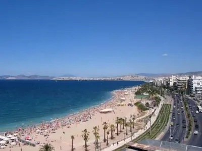 a view of a beach with people and the ocean at Renovated fully equipped 2 Bedroom cozy Apartment near the sea in Athens