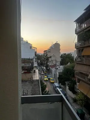 a view from a balcony of a street with cars at Petralona modern apartment near metro & Acropolis in Athens