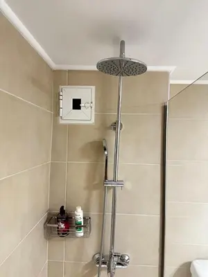 a shower with a glass door in a bathroom at Petralona modern apartment near metro & Acropolis in Athens