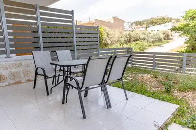 a table and chairs sitting on a patio at Athens Airport Zen House in Paianía
