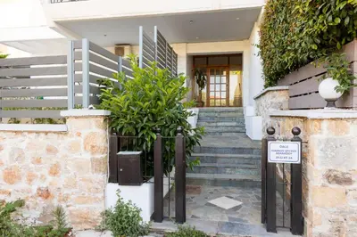 a house with stairs and a sign in front of it at Athens Airport Zen House in Paianía