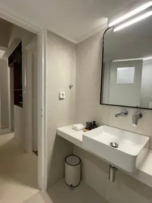 a bathroom with a white sink and a mirror at Marmaronetta in Athens
