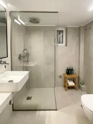 a bathroom with a shower and a toilet and a sink at Marmaronetta in Athens