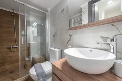 a bathroom with a sink and a shower and a toilet at Acropolis Walk Residence by MDK Athens in Athens