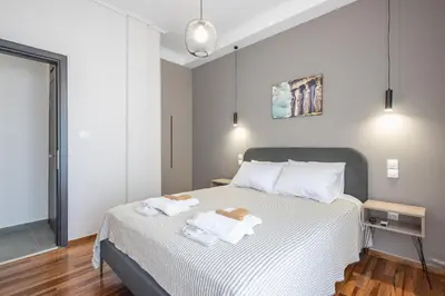 a bedroom with a bed with two towels on it at Acropolis Walk Residence by MDK Athens in Athens