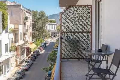 a balcony with a table and a city street at Acropolis Walk Residence by MDK Athens in Athens