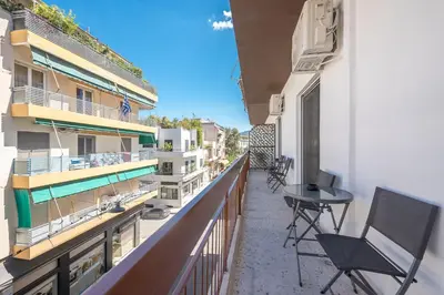 a balcony with chairs and a table on a building at Acropolis Walk Residence by MDK Athens in Athens