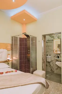 a hotel room with a bed and a shower at Gazi Suite with Private Rooftop in Athens