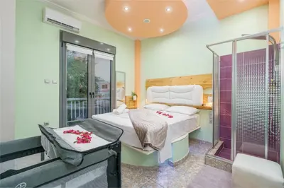 a bedroom with two beds and a shower at Gazi Suite with Private Rooftop in Athens