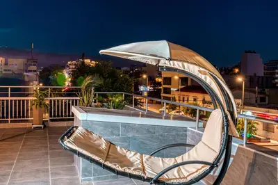 a slide on the roof of a building at night at Gazi Suite with Private Rooftop in Athens