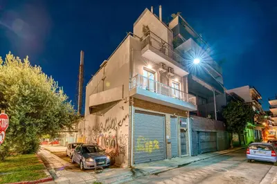 a building with cars parked in front of it at Gazi Suite with Private Rooftop in Athens