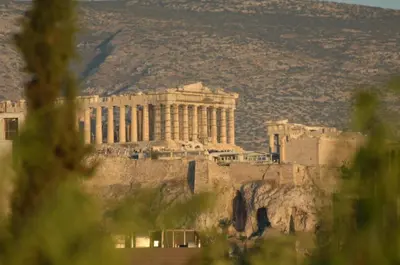 a view of the acropolis of athens seen through trees at Gazi Suite with Private Rooftop in Athens