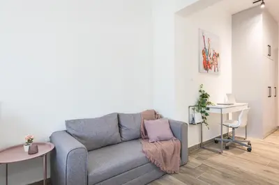 a living room with a couch and a table at Kallithea Kyprou Square ! in Athens