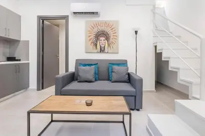 a living room with a couch and a coffee table at Oculus Kalithea Irakleous Apartments by Live&Travel in Athens