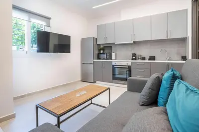 a living room with a couch and a table at Oculus Kalithea Irakleous Apartments by Live&Travel in Athens