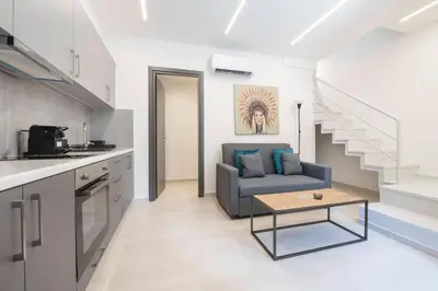 a living room with a couch and a table at Oculus Kalithea Irakleous Apartments by Live&Travel in Athens