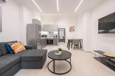 a living room with a couch and a table at Oculus Kalithea Irakleous Apartments by Live&Travel in Athens