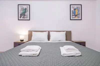 a bedroom with a bed with two towels on it at Oculus Kalithea Irakleous Apartments by Live&Travel in Athens