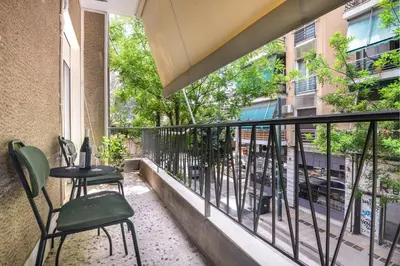a balcony with two chairs and a table at Koukaki Beat in Athens