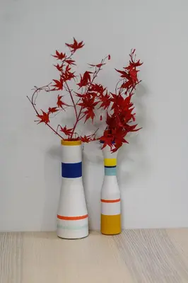 two colorful vases with a plant in them at Koukaki Beat in Athens