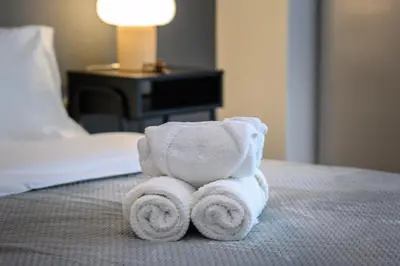 a towel animal is sitting on a bed at Koukaki Beat in Athens