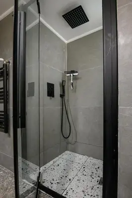 a shower in a bathroom with a glass shower stall at Koukaki Beat in Athens