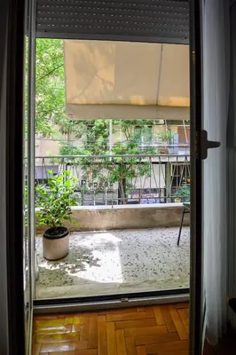a view of a patio from a window with a plant at Koukaki Beat in Athens