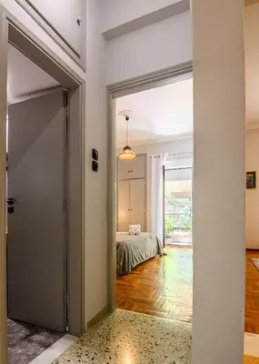 a hallway with a door leading to a bedroom at Koukaki Beat in Athens