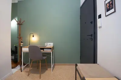 a desk in a room with a chair and a door at Koukaki Beat in Athens