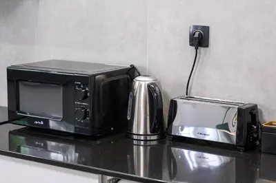 a microwave and a toaster sitting on a counter at Koukaki Beat in Athens