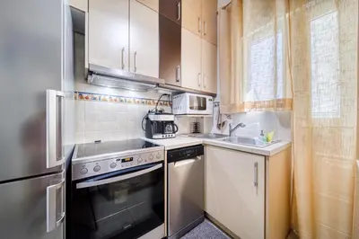 a small kitchen with a stove and a sink at Manolias apartment in Athens
