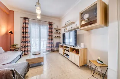 a living room with a bed and a tv in it at Manolias apartment in Athens