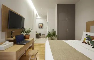 a bedroom with a bed and a laptop on a desk at Filolaou Athens Luxury Apartment by Mystery in Athens