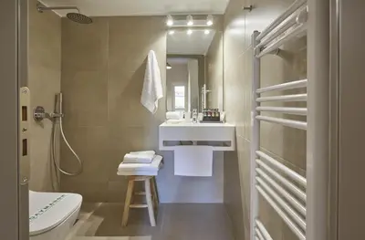 a bathroom with a sink and a toilet and a mirror at Filolaou Athens Luxury Apartment by Mystery in Athens