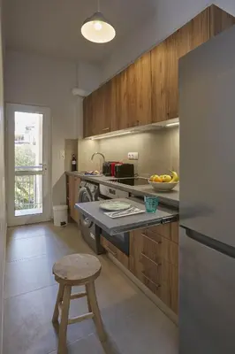 a kitchen with a counter with a bowl of fruit at Filolaou Athens Luxury Apartment by Mystery in Athens