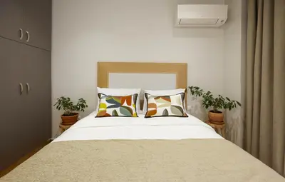 a bedroom with a large bed with two pillows at Filolaou Athens Luxury Apartment by Mystery in Athens