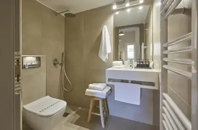 a bathroom with a toilet and a sink at Filolaou Athens Luxury Apartment by Mystery in Athens