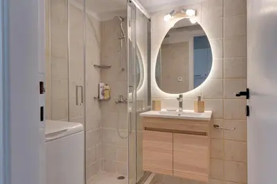 a bathroom with a shower and a sink and a mirror at Historical center Athens amazing studio in Athens