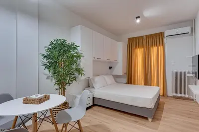 a bedroom with a bed and a table and a table and chairs at Historical center Athens amazing studio in Athens