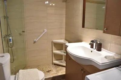 a bathroom with a sink and a shower at Panorama Γλυκά Νερά - Athens in Glyka Nera