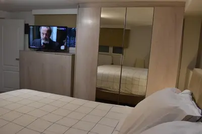 a bedroom with a tv in a mirror at Panorama Γλυκά Νερά - Athens in Glyka Nera