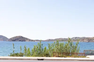 a view of a body of water with mountains at The Pines apartment in Palaiá Fókaia